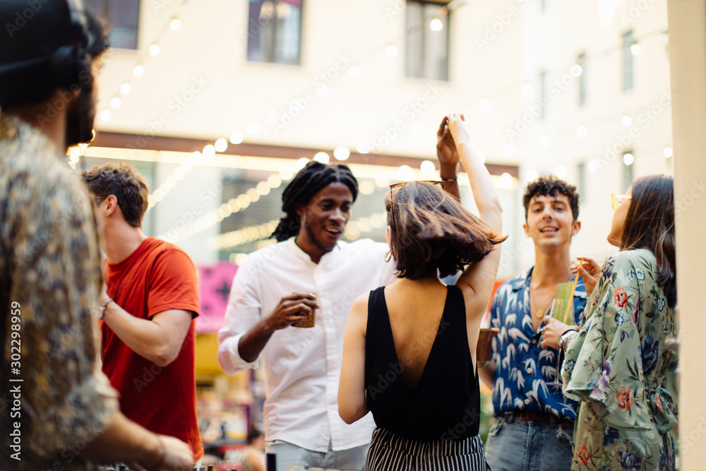 Happy multi-ethnic friends having fun during a party Happy multi-ethnic friends having fun during a party