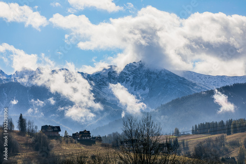 HDR photo of the Tatra Mountains and Great Giewont Peak with the steel Cross between clouds.