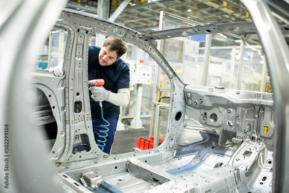 Man working in modern car factory Man working in modern car factory