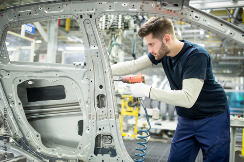 Man working in modern car factory photo