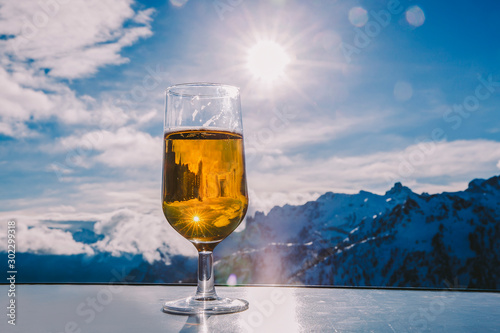 Glass of beer with the Serre Chevalier Alps in the background, France