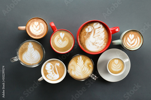 Buch of coffee cups with different kind of beverage and different latte art foam designs. Top view, close up, copy space, background.