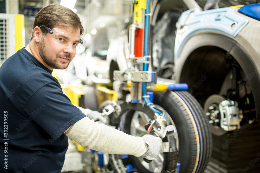 Portrait of confident worker in modern car factory Portrait of confident worker in modern car factory