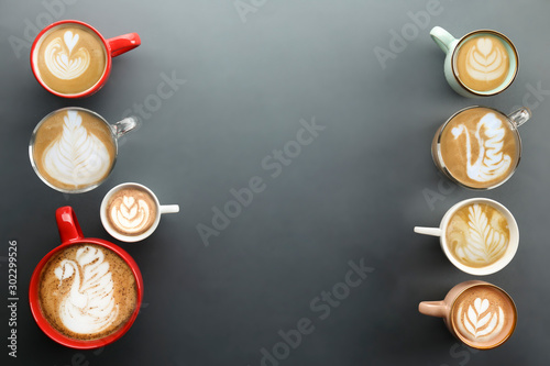 Buch of coffee cups with different kind of beverage and different latte art foam designs. Top view, close up, copy space, background.