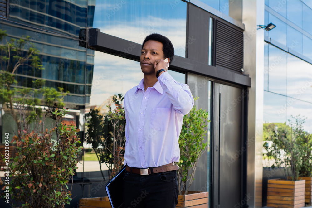 Latin businessman talking on mobile phone Latin businessman talking on mobile phone