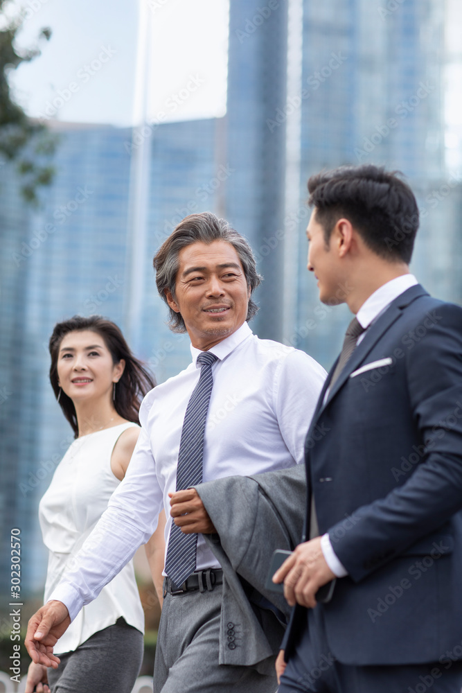 Successful Chinese business people walking on street Successful Chinese business people walking on street