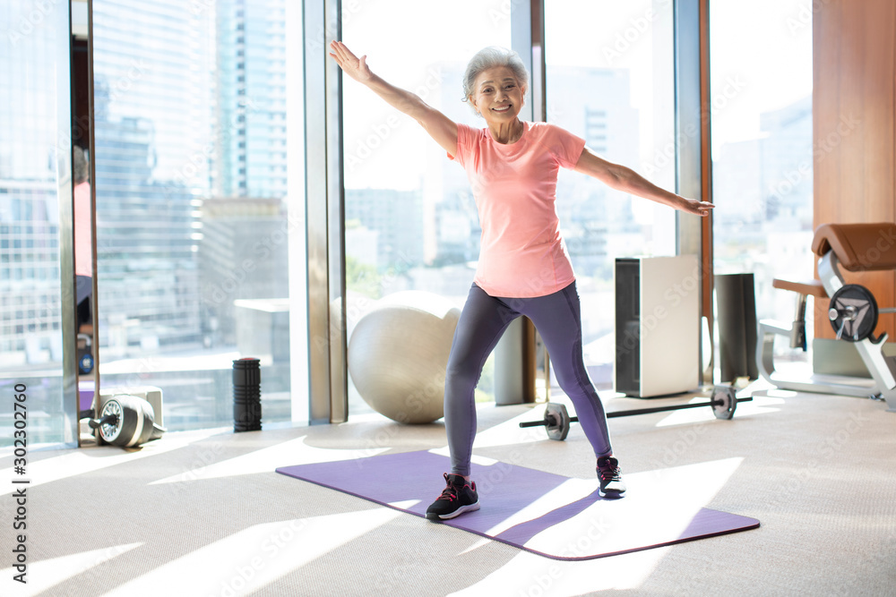 Senior Chinese woman exercising at gym Senior Chinese woman exercising at gym