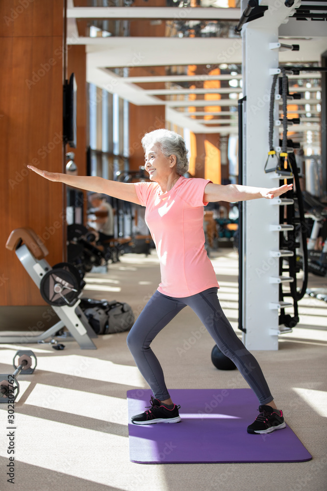 Senior Chinese woman exercising at gym Senior Chinese woman exercising at gym