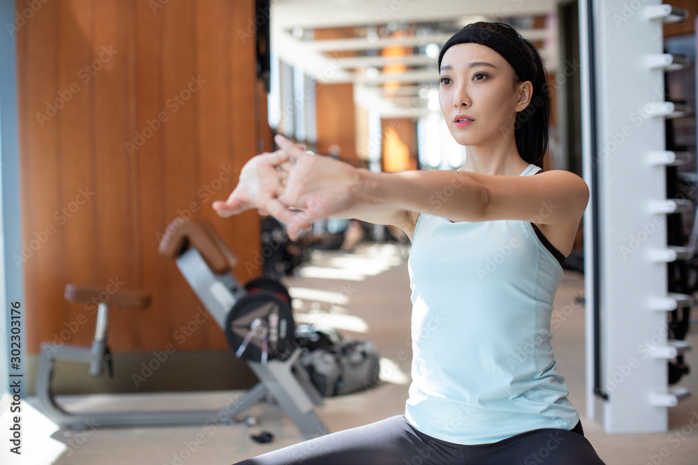 Young Chinese woman exercising at gym Young Chinese woman exercising at gym