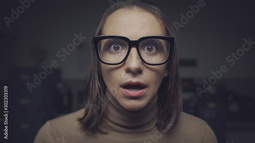 Shocked scared woman staring at camera