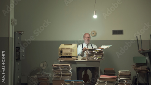 Frustrated businessman overloaded with paperwork photo