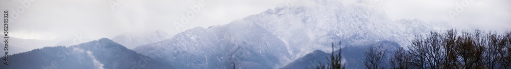Obraz premium Panorama HDR of the Tatra Mountains and Zakopane in Poland, National Park, pictures taken in cloudy day.