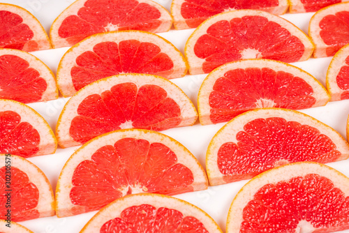 Grapefruit red juicy slices background. top view.