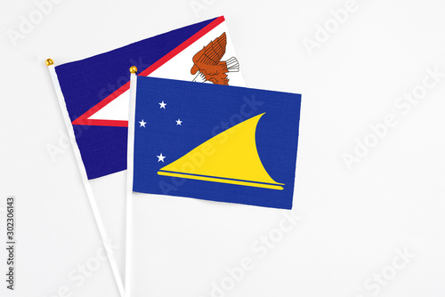 Free Download Tokelau and American Samoa stick flags on white background. High quality fabric, miniature national flag. Peaceful global concept.White floor for copy space. - GFXLoad