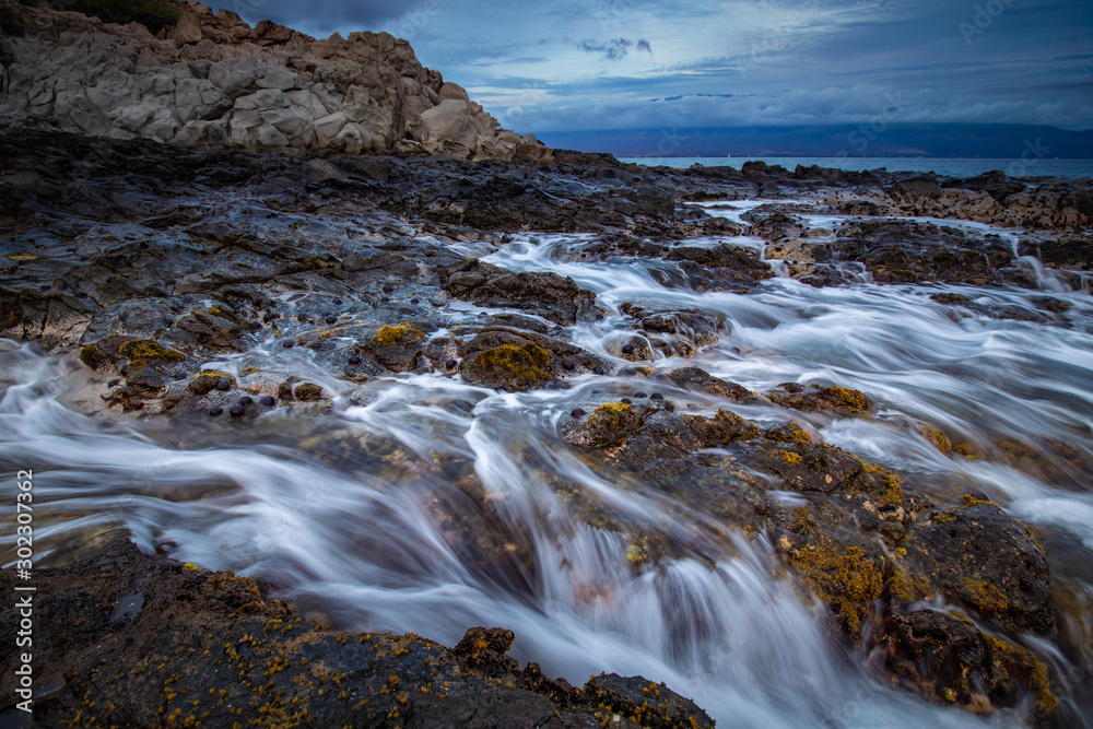 Rocky Coastline with waves at sunset from Maui