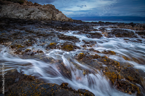 Rocky Coastline with waves at sunset from Maui