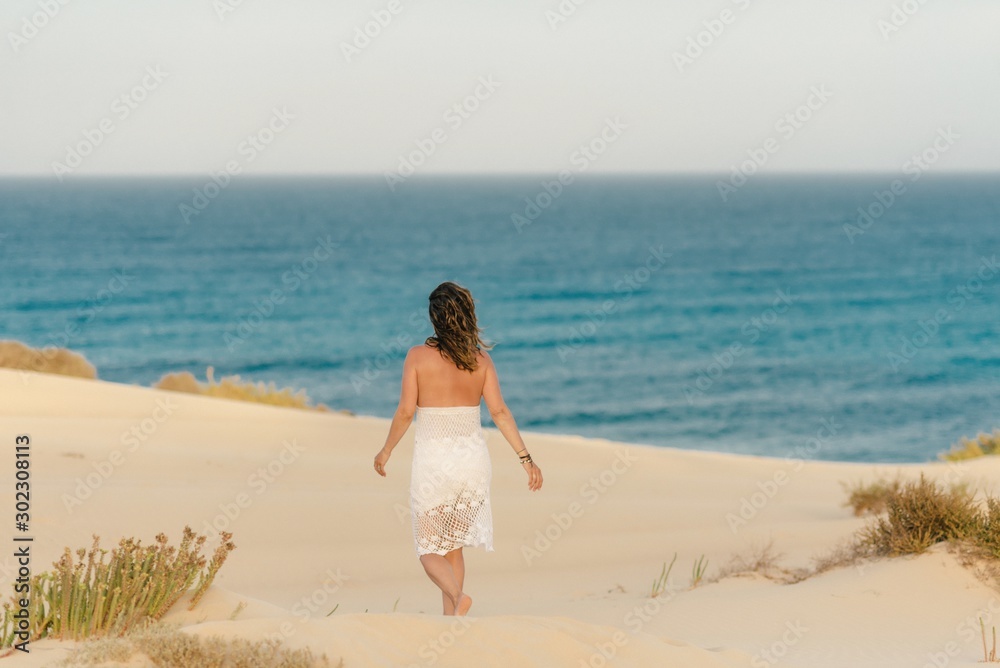 Active woman in white shorts walking sandy beach Active woman in white shorts walking sandy beach
