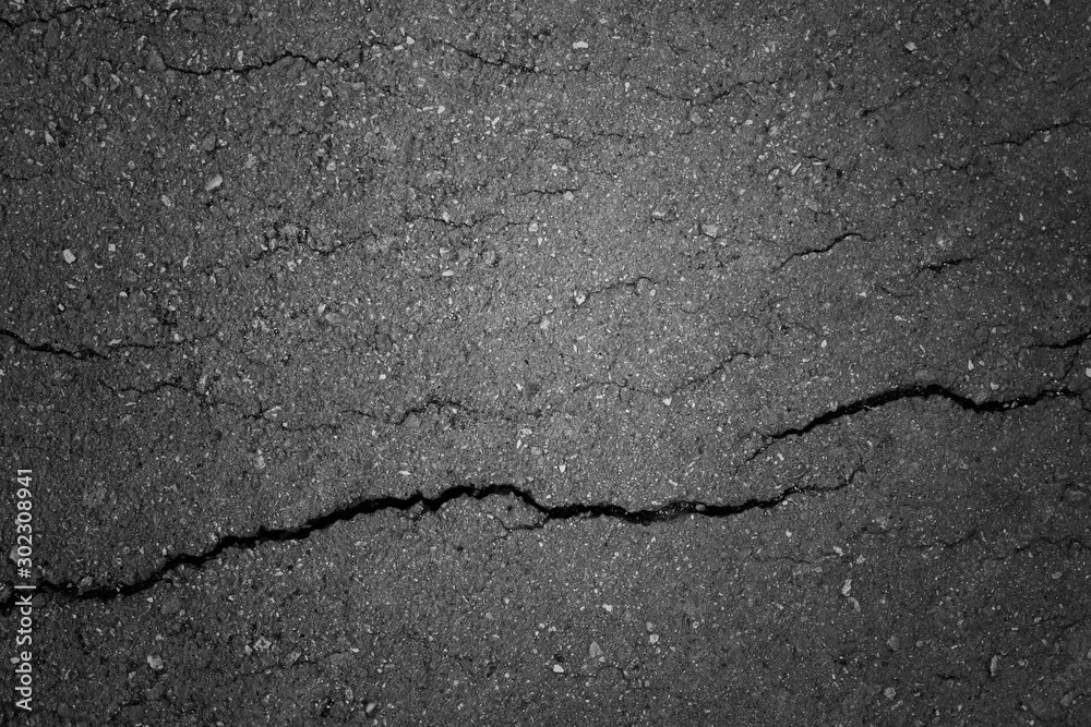 Obraz premium Top view of an old cracked abandoned pedestrian asphalt path made of small stones. Beautiful modern abstract trendy grunge texture background. Design element.