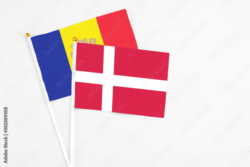 Denmark and Andorra stick flags on white background. High quality fabric, miniature national flag. Peaceful global concept.White floor for copy space.