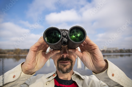 Man looking through the binoculars