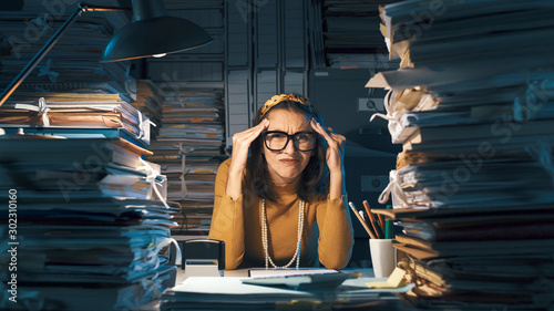Confused office worker sitting at desk