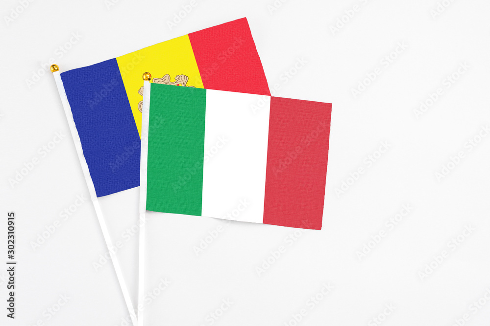 Italy and Andorra stick flags on white background. High quality fabric, miniature national flag. Peaceful global concept.White floor for copy space. Italy and Andorra stick flags on white background. High quality fabric, miniature national flag. Peaceful global concept.White floor for copy space.