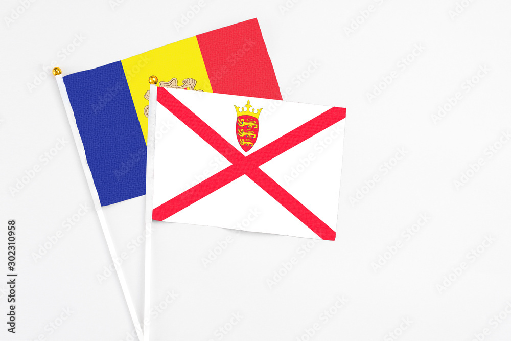 Jersey and Andorra stick flags on white background. High quality fabric, miniature national flag. Peaceful global concept.White floor for copy space. Jersey and Andorra stick flags on white background. High quality fabric, miniature national flag. Peaceful global concept.White floor for copy space.