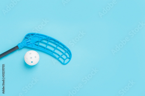 Obraz na plátně floorball stick and white ball isolated on blue background