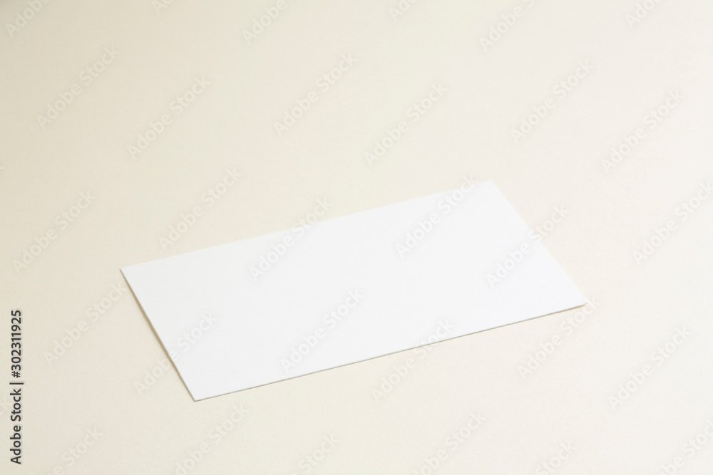 Standard empty white business card template on bone coloured background. Perspective angle with soft shadows. For branding identity, logo design pitches and marketing. Standard empty white business card template on bone coloured background. Perspective angle with soft shadows. For branding identity, logo design pitches and marketing.