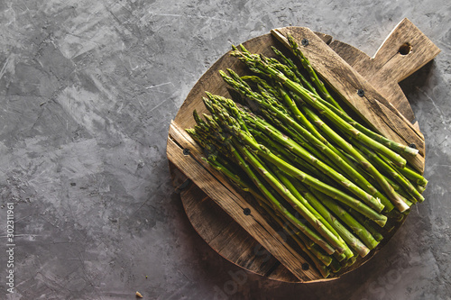 Asparagus on a cutting board. Healthy food  health on a concrete background.
