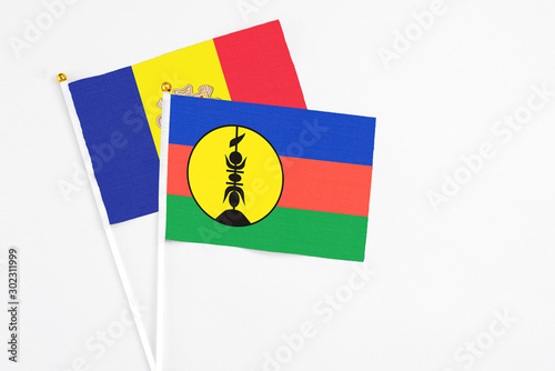 New Caledonia and Andorra stick flags on white background. High quality fabric, miniature national flag. Peaceful global concept.White floor for copy space. Free Download New Caledonia and Andorra stick flags on white background. High quality fabric, miniature national flag. Peaceful global concept.White floor for copy space. - GFXLoad
