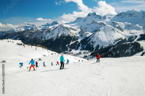 Skiers on the track in the winter mountains