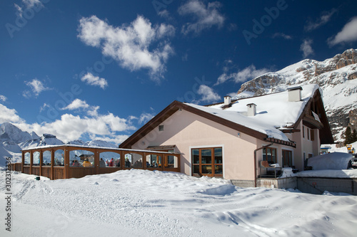 Mountain restaurant with terrace in Italian Alps in sunny winter day