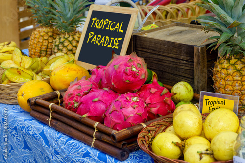 Tropical fruit display of guava, star fruit, pineapple, and dragon fruit photo