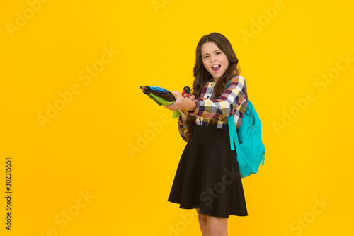Sharp look. Small girl with autumn look on yellow background. Little child hold stick umbrella with school look. Fashion look of adorable schoolchild. Brighten up the cloudiest day, copy space