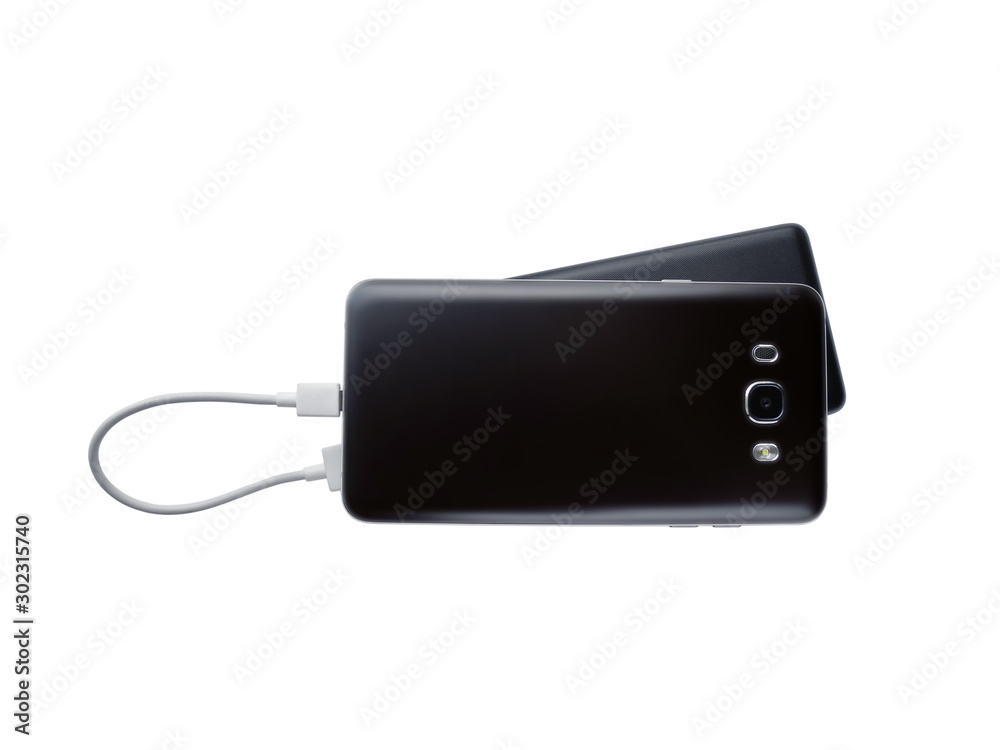 Black cell phone is charging using power bank with usb cabel. Mobile and external battery isolated on white background, top view. Black cell phone is charging using power bank with usb cabel. Mobile and external battery isolated on white background, top view.