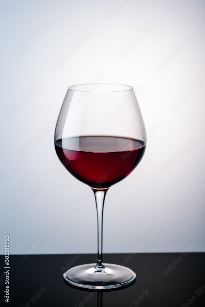 red wine in a wine glass on the background red wine in a wine glass on the background