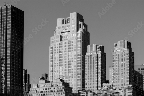 black and white photo of vintage skyscrapers along 15 central park avenue in New York  NY  United States
