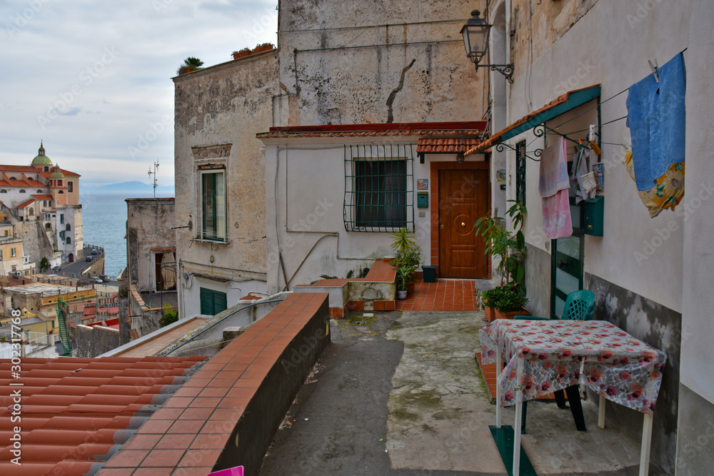 Obraz premium Atrani coast, Italy, 12/12/2017. The narrow street among the old houses of a coastal village