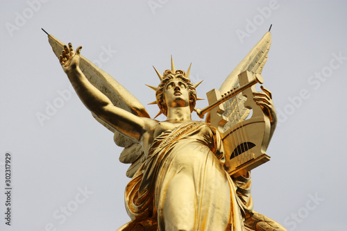 detail of the golden statue above the opera house of Paris