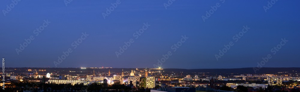 Dresden in Germany by night, panoramic view to the town center with the old town and residential areas