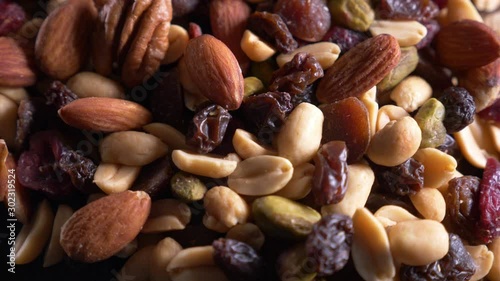 Roasted and salted nuts (mixed) on an old wooden table