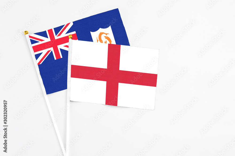 England and Anguilla stick flags on white background. High quality fabric, miniature national flag. Peaceful global concept.White floor for copy space.
