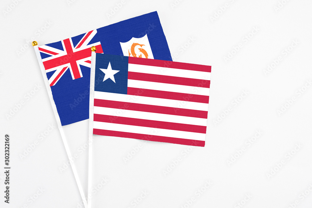 Liberia and Anguilla stick flags on white background. High quality fabric, miniature national flag. Peaceful global concept.White floor for copy space. Liberia and Anguilla stick flags on white background. High quality fabric, miniature national flag. Peaceful global concept.White floor for copy space.