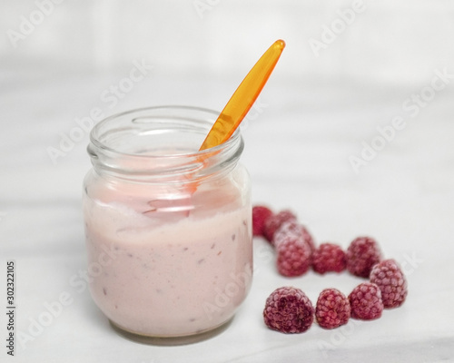 a yogurt with a raspberry