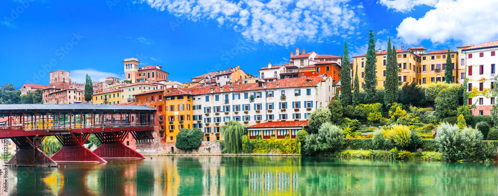 Beautiful medieval towns of Italy -picturesque  Bassano del Grappa .Scenic view with famous bridge. Vicenza province,  region of Veneto - obrazy, fototapety, plakaty 