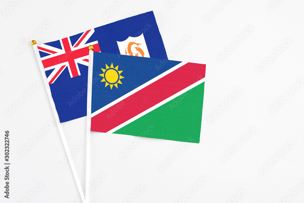 Namibia and Anguilla stick flags on white background. High quality fabric, miniature national flag. Peaceful global concept.White floor for copy space. Namibia and Anguilla stick flags on white background. High quality fabric, miniature national flag. Peaceful global concept.White floor for copy space.