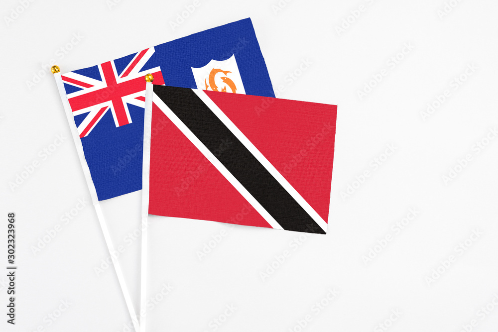 Trinidad And Tobago and Anguilla stick flags on white background. High quality fabric, miniature national flag. Peaceful global concept.White floor for copy space. Trinidad And Tobago and Anguilla stick flags on white background. High quality fabric, miniature national flag. Peaceful global concept.White floor for copy space.