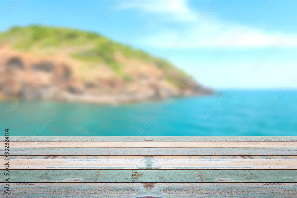 Wood table top with blurred nature scene tropical beach