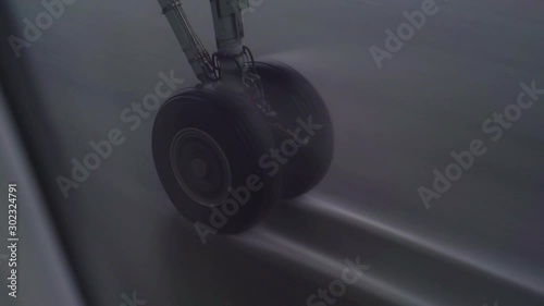 Airplane landing gear landing touch down in heavy rain